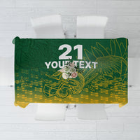 Green and yellow cricket-themed tablecloth with dragon graphic and large number design