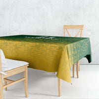 Green and yellow cricket-themed tablecloth draped over table edge with geometric pattern