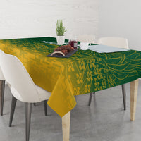 Green and yellow cricket-themed tablecloth on dining table with chairs and center arrangement