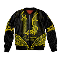 Black bomber jacket with gold barong-style patterns, front zip, ribbed collar and cuffs.