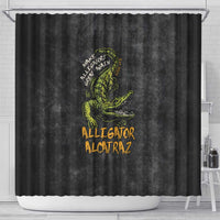 Black shower curtain with green alligator graphic and 'Alligator Alcatraz' lettering