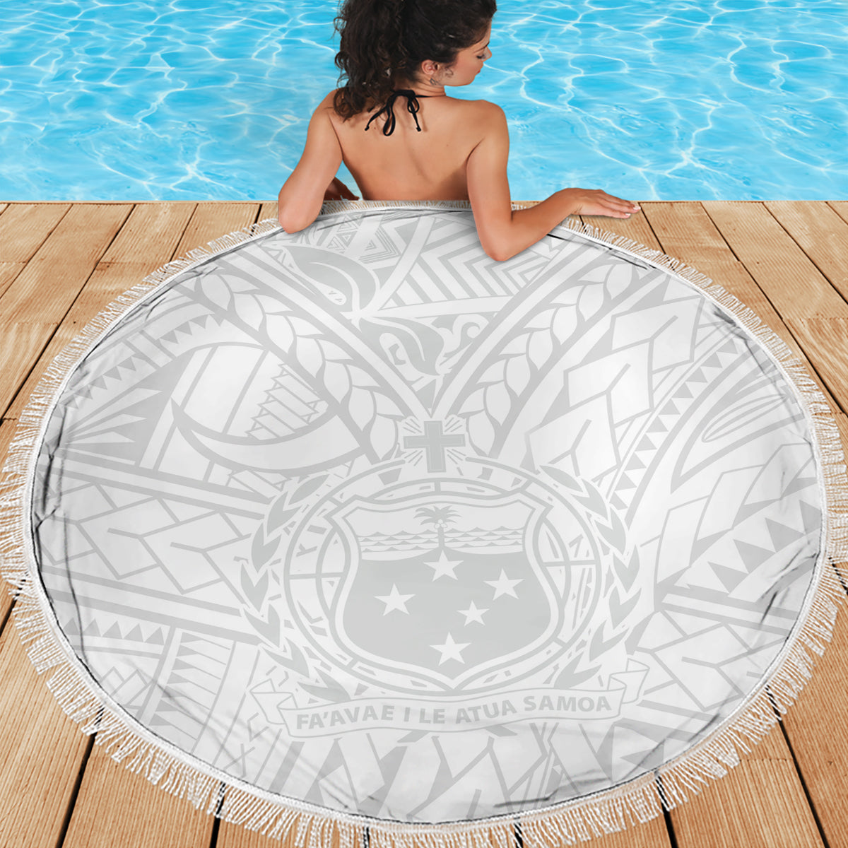 Round white beach blanket with gray Polynesian crest pattern and white tassel fringe