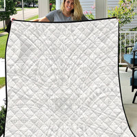 White children's quilt with diamond stitch pattern and black edge trim.