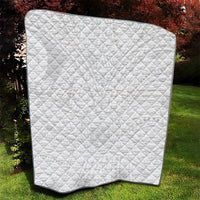 White quilt with diamond stitch top and black corner binding.