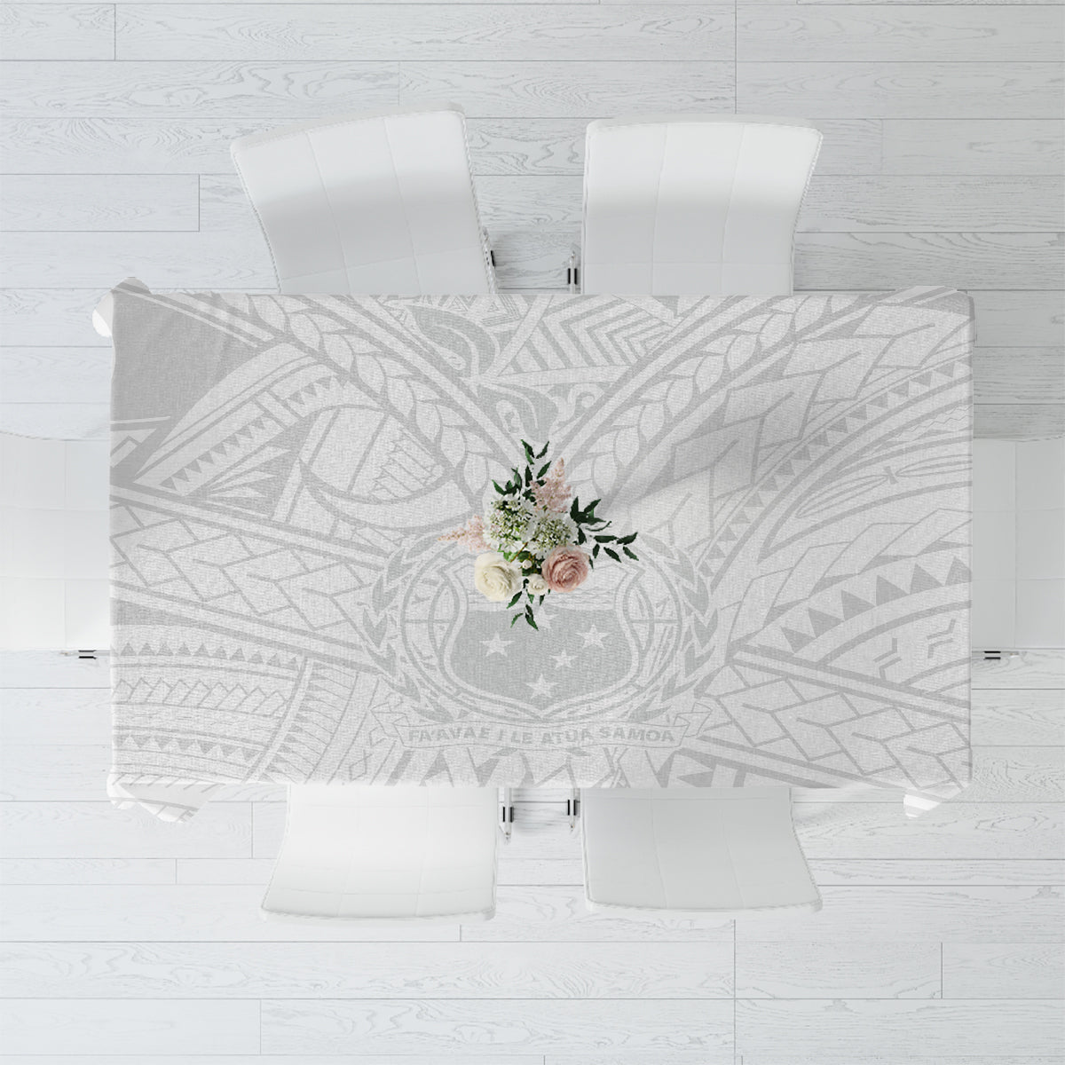 White tablecloth with gray leaf-and-triangle geometric pattern and floral centerpiece
