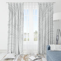 White patterned window curtains with geometric motifs, centered over a room window