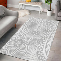 White area rug with tropical leaf medallion center and geometric side pattern