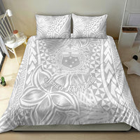 White Polynesian bedding set with large leaf-and-floral print and geometric triangles; duvet and two pillows