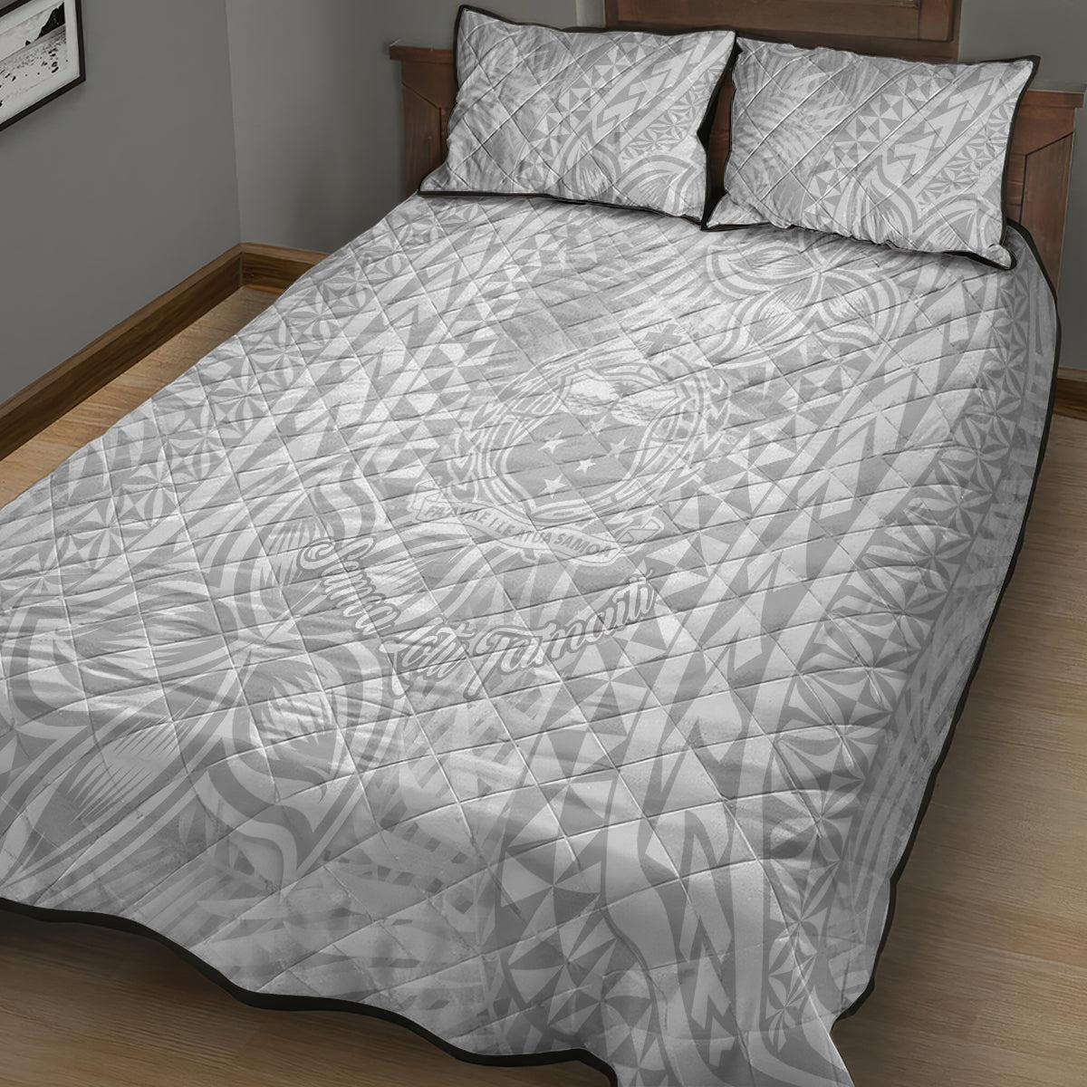 White quilt and two pillowcases with repeating tropical pattern