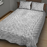 White quilt and two pillowcases with repeating tropical pattern