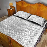 White quilt with black border and two pillowcases, tropical geometric design