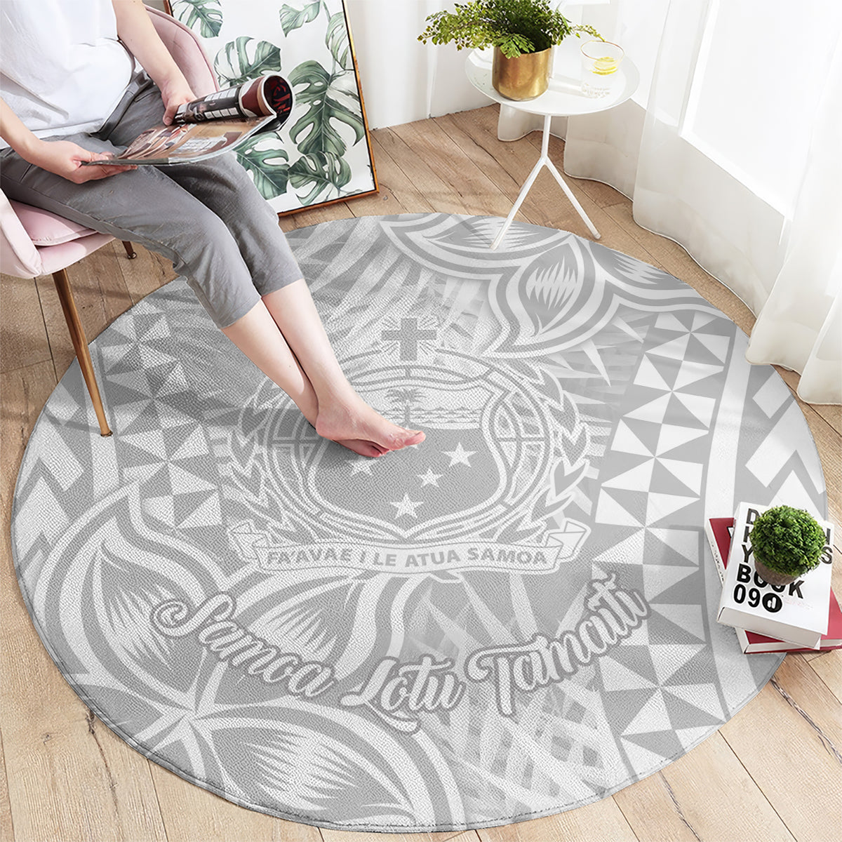 Round gray rug with white Polynesia crest motif and geometric pattern