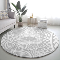 Round gray-and-white Polynesian rug with central crest and star accents