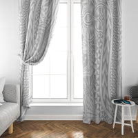 White tropical patterned curtain panels framing a glass door