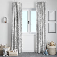 White window curtain panels with geometric and leaf swirls, side view