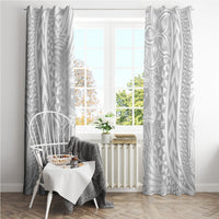 White tropical patterned curtains hung on a rod, side panels visible