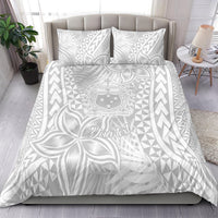 White bedding set with two pillowcases on bed, tropical polynesian pattern duvet cover