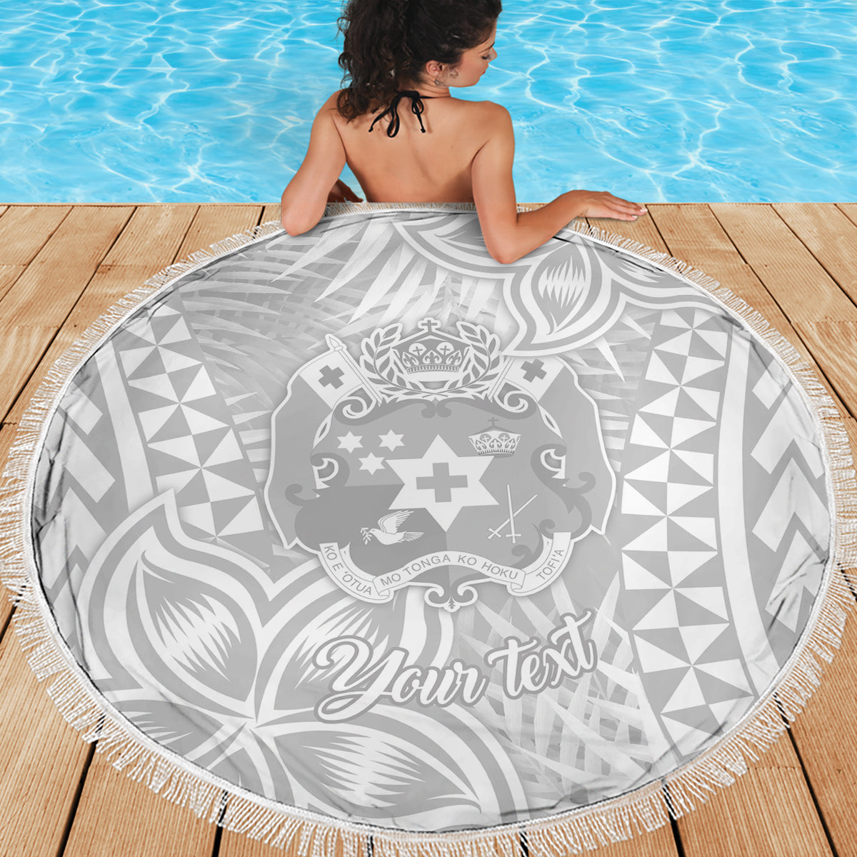 Round Polynesian print beach blanket in white and gray with “Your text” and fringe