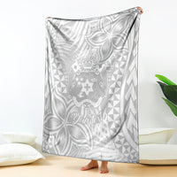 Folded personalized white blanket with gray Polynesian crest, leaves, and triangle pattern