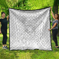 White quilt blanket with black border, tropical polynesian-style print and text