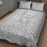 White quilt bed set with two pillows, swirling geometric tropical pattern and black piping