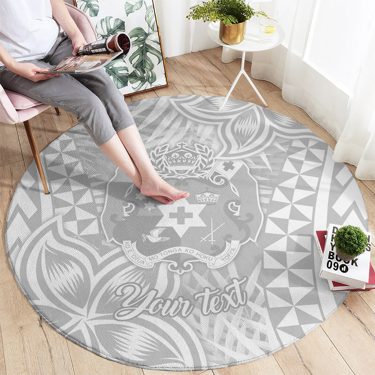 Round gray floor rug with white geometric and Polynesian design, featuring “Your text”