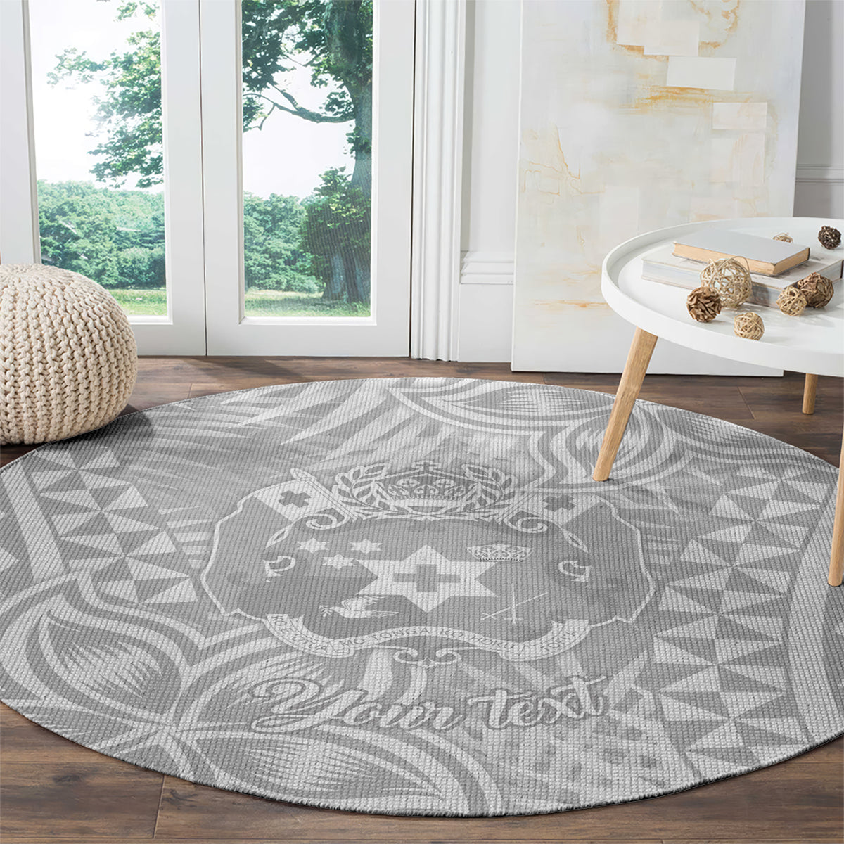 Round gray rug with white Polynesian crest and geometric pattern, “Your text”