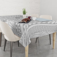 Tablecloth on dining table, white with gray Polynesian geometric and leaf pattern