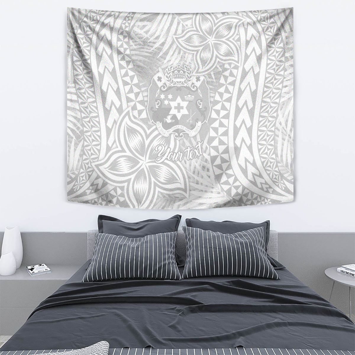 White wall tapestry with geometric borders, tropical leaves, and central crest design