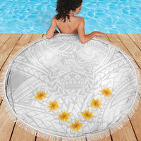Round white beach blanket with gray tribal motif, yellow plumeria flowers, and fringed border