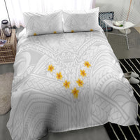 White duvet cover with tribal motifs and yellow plumeria clusters; includes two matching pillows