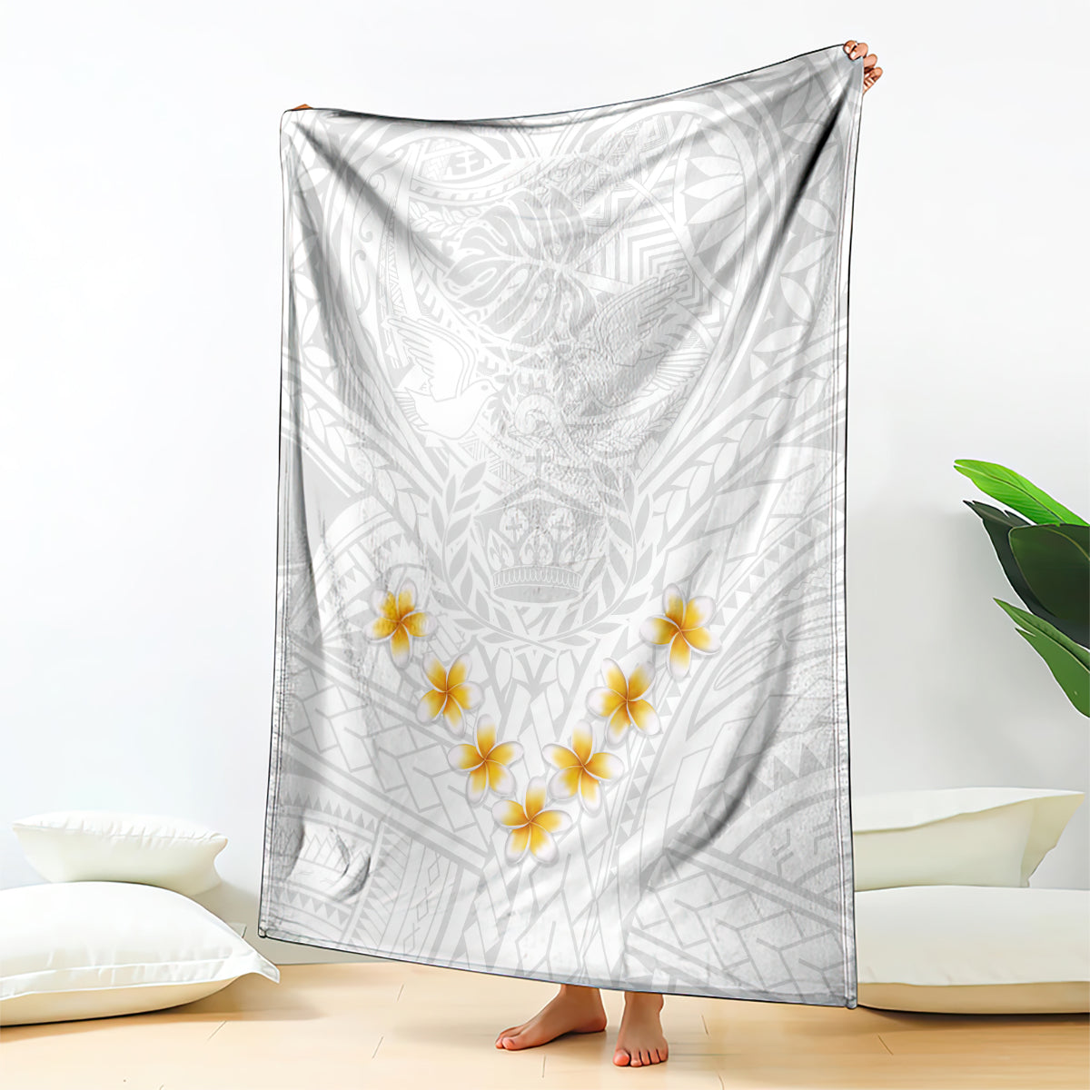 White blanket with white tribal leaves and gray pattern, with yellow plumeria flowers.