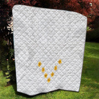 White quilt with diamond stitching and small yellow plumeria wreath applique