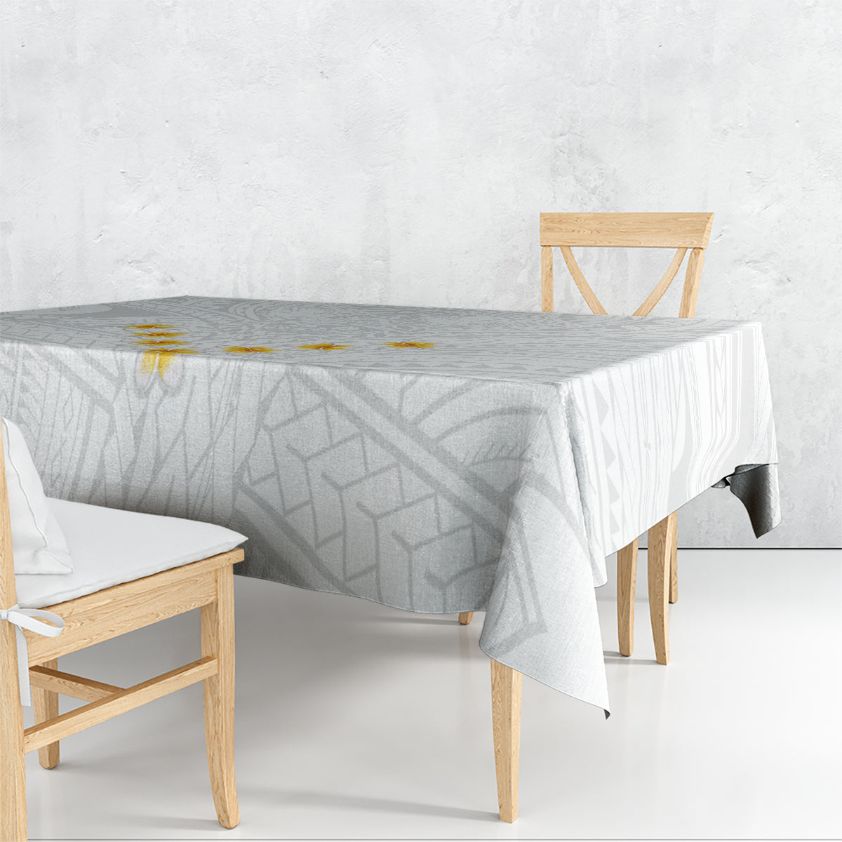 Gray and white tablecloth with geometric pattern draped over dining table