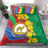 Green duvet and two pillowcases with yellow flowers and camel emblem