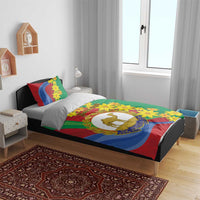 Green duvet cover with pillowcases, yellow flower pattern, and camel crest