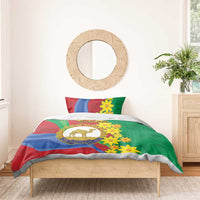 Green duvet with matching pillowcases, blue red swirls, yellow flowers, camel logo
