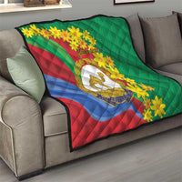 Green quilt on a couch with Eritrea stripes, yellow flowers, camel emblem, custom text.