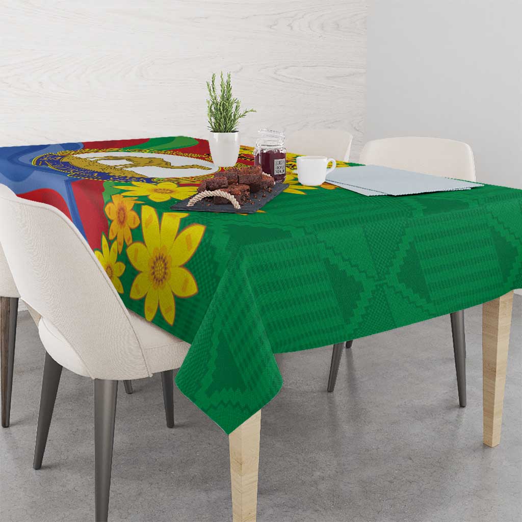 Green tablecloth with yellow flower design and Eritrea-style flag colors