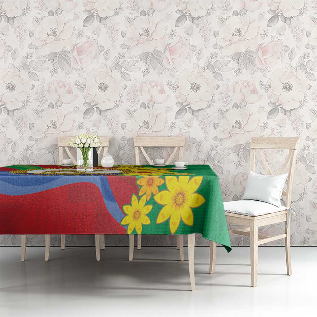 Green tablecloth featuring Eritrea flag colors, lion emblem, and yellow flowers