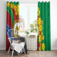 Hanging window curtains with yellow floral print and camel emblem on green and striped panels