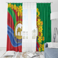 Grommet-top window curtains: green panel with yellow flowers and striped panel with camel emblem