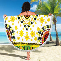 White round beach blanket with yellow floral print and colorful central V motif, fringed