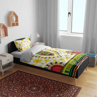 White duvet and pillow set with yellow flowers, multicolor border, and red circular motif