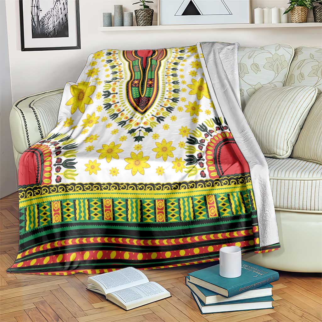 White dashiki-pattern blanket with yellow flowers and colorful green red border trim