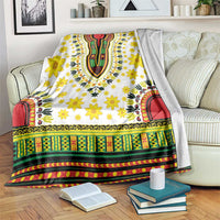 White dashiki-pattern blanket with yellow flowers and colorful green red border trim