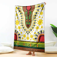White blanket with bold dashiki motifs, yellow flowers, red and green banded border