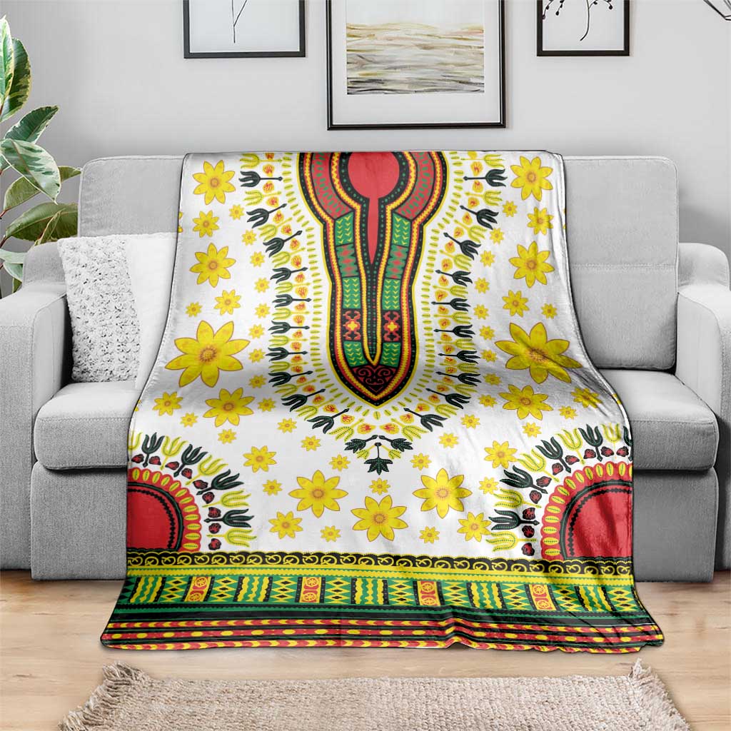 White dashiki-style blanket with yellow flower print and multicolor geometric stripe bottom