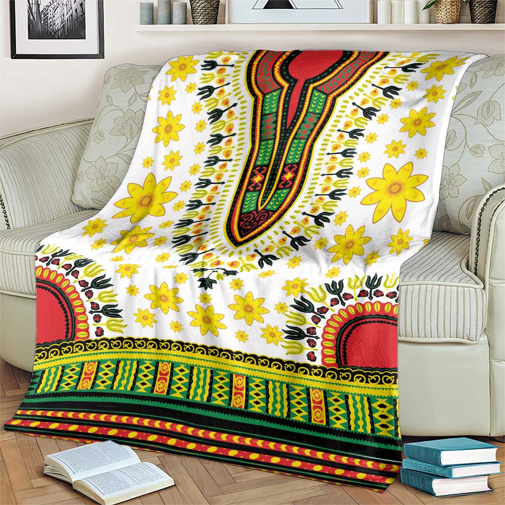 White floral dashiki blanket with yellow blossoms and multicolor patterned border on sofa