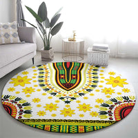 Round white rug with yellow floral pattern and green/red/black dashiki-style banded edge